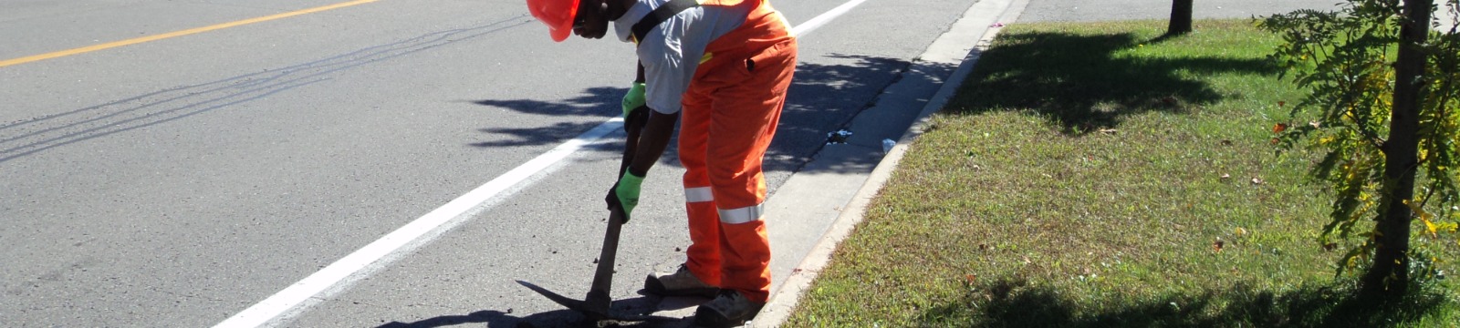 Worker repairing road