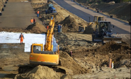 A backhoe working on road restructuring