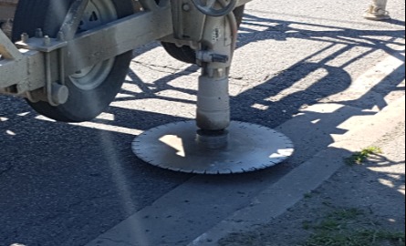 a circular saw cutting the curb