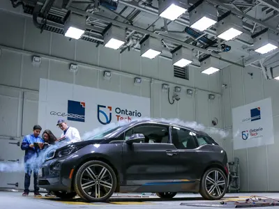 ACE staff reviewing car