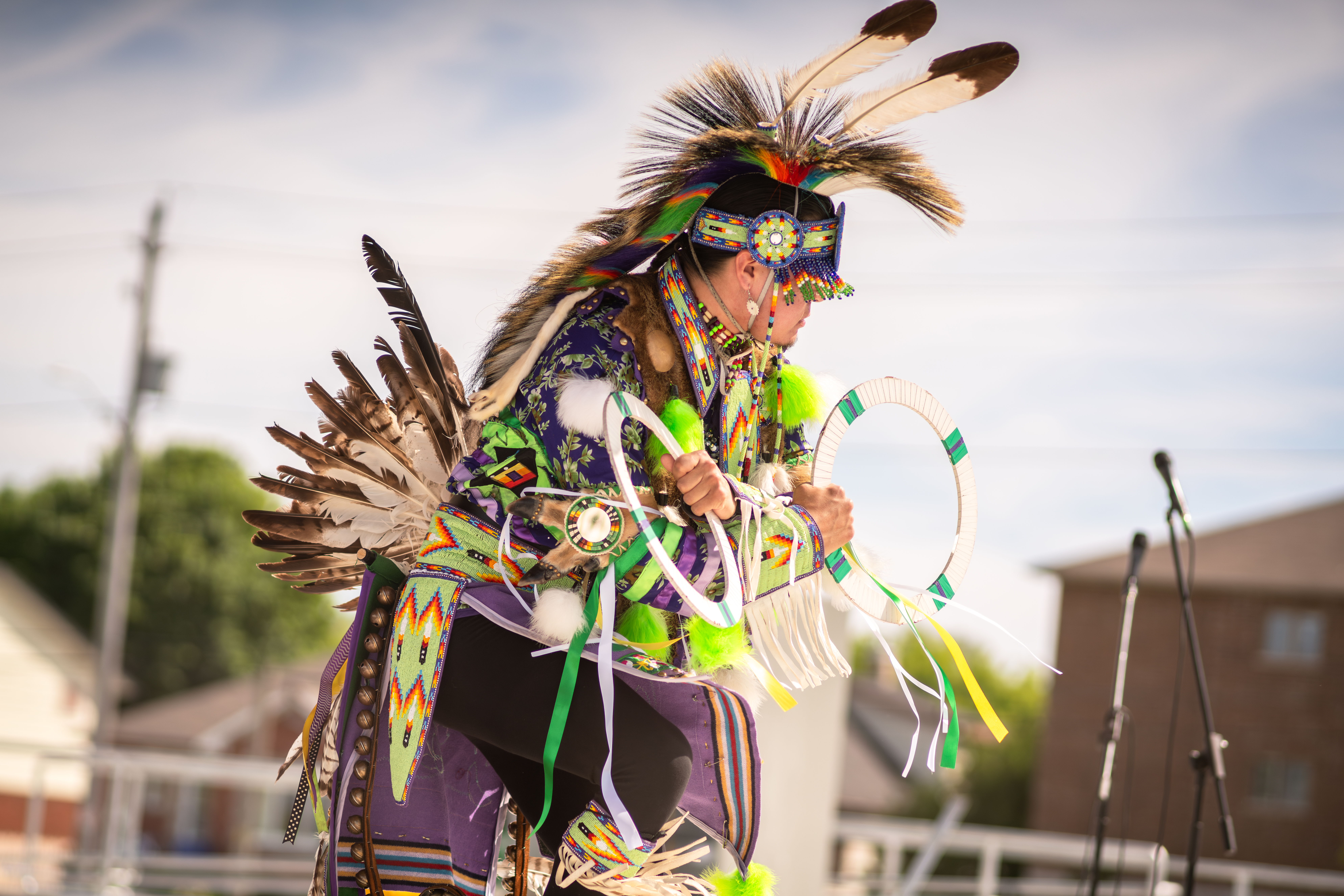 man in regalia hoop dance