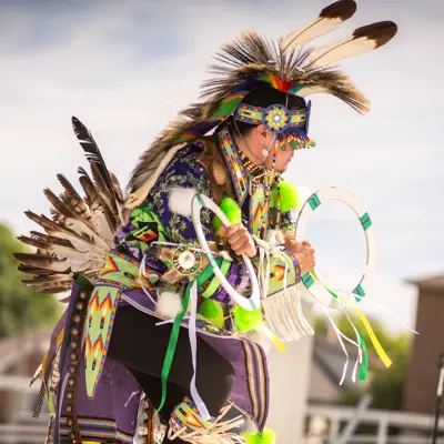 man in regalia hoop dance