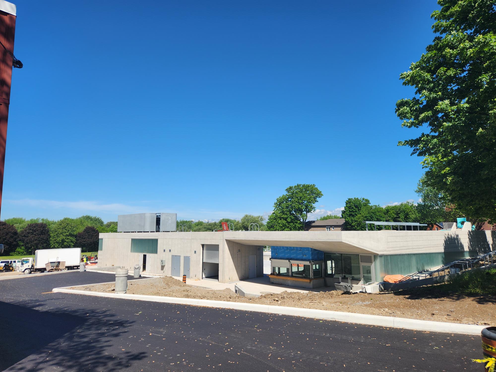 View of Centre St parking lot and front entrance of Rotary Park. Looking north towards Monck Street.