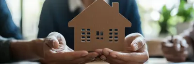 Person holding an outline of a house