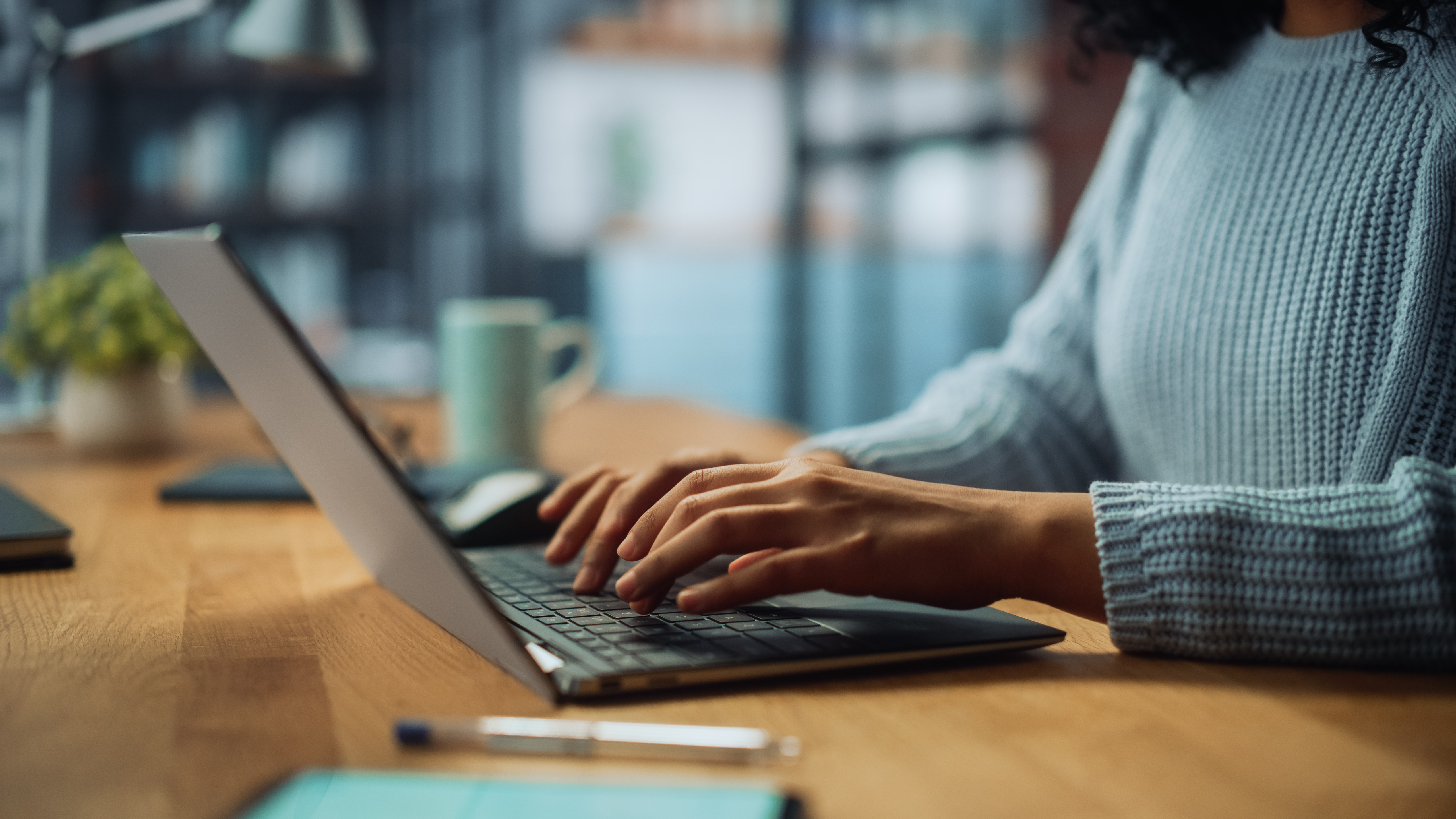 Woman typing on laptop keyboard