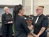 Couple holding hands before wedding officiant