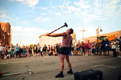strongman busker performing with sledgehammer