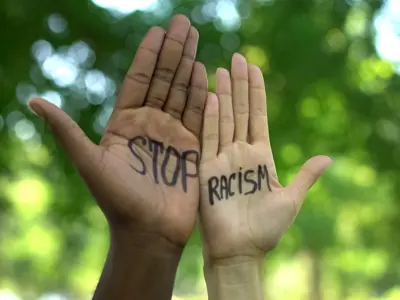 Two hands with the words Stop Racism on them