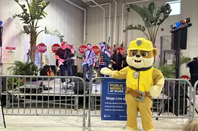 Paw Patrol costume character in front of stage with band