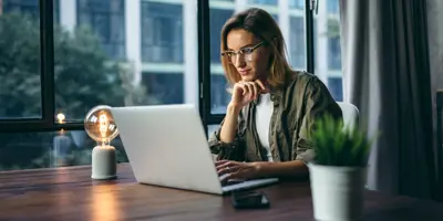 person at a desk working on a computer