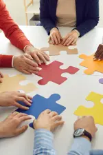 people putting a puzzle together