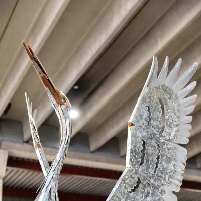 Metal sculpture of a heron by Geordie Lishman titled Inspiration Taking Flight