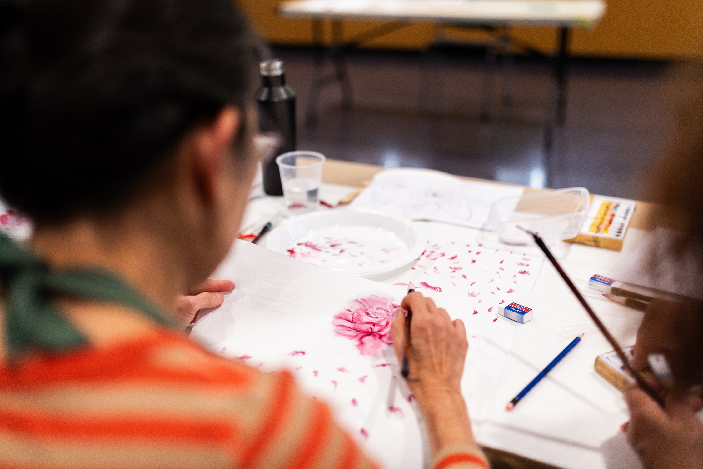 Class participation painting a pink flower