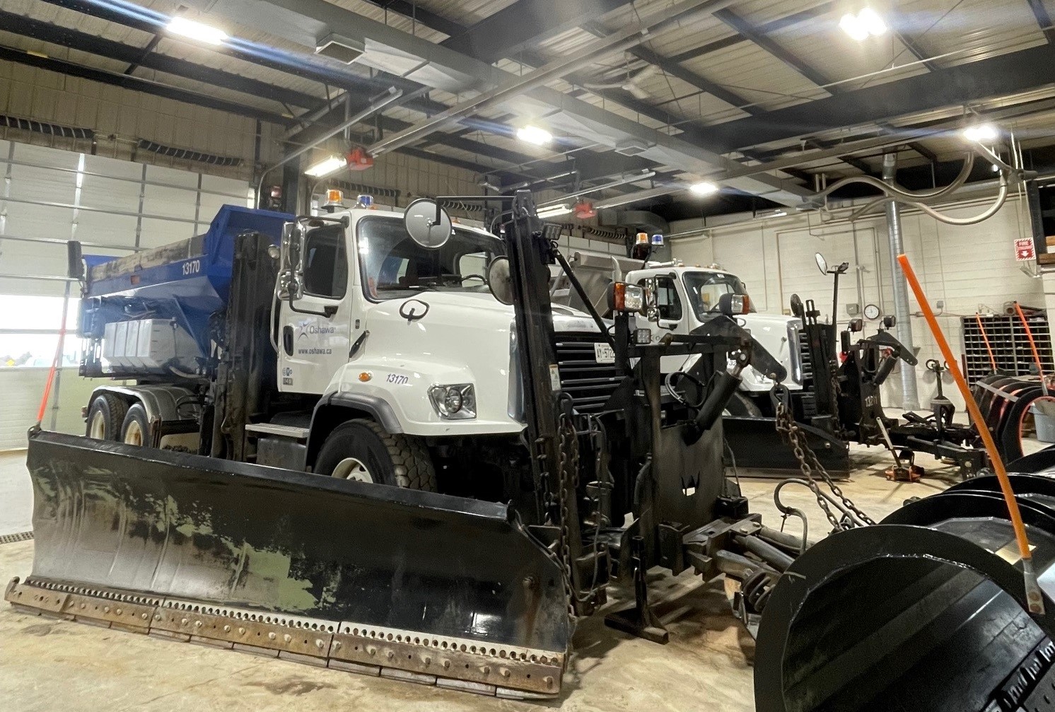 Oshawa snow plows in garage