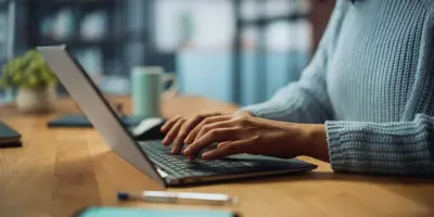 hands typing on laptop