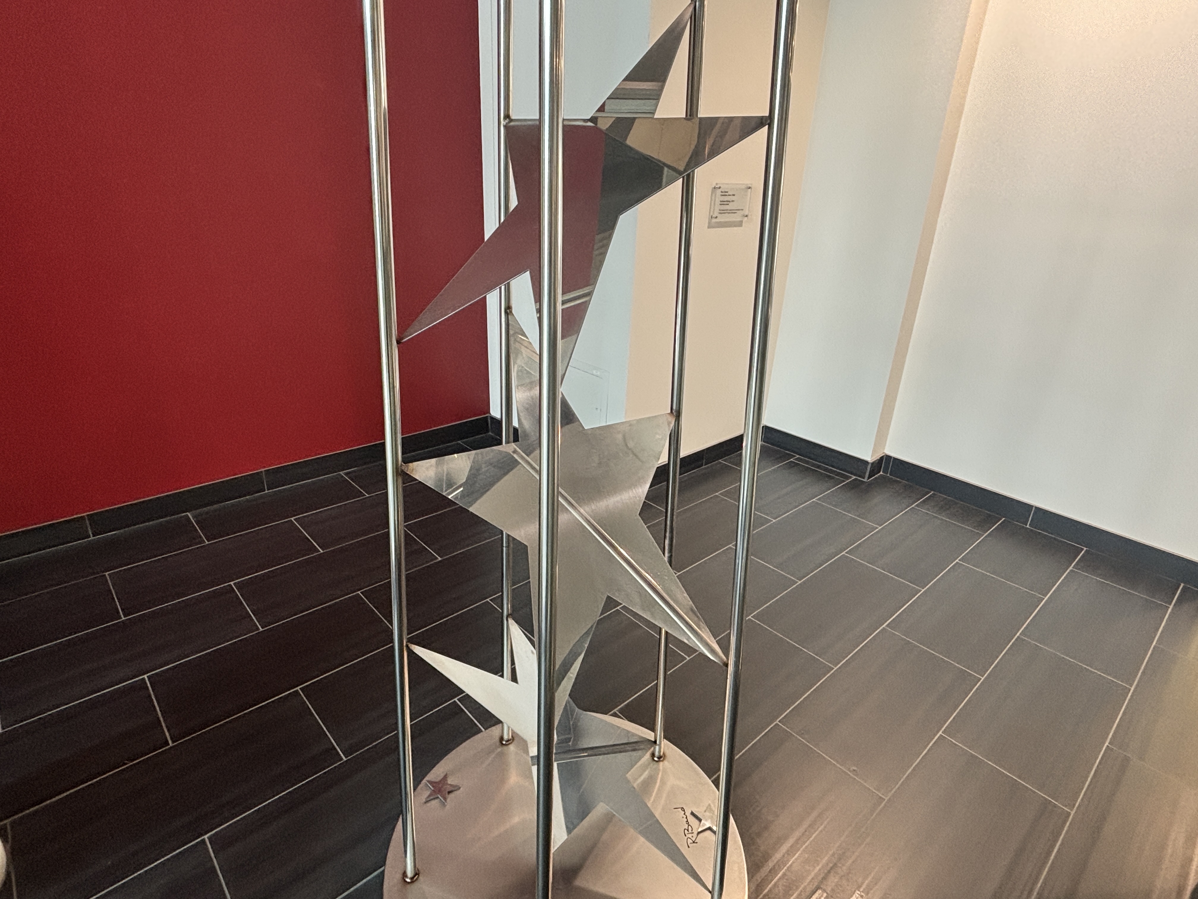 Stainless steel sculpture in City Hall of a tower of stars.