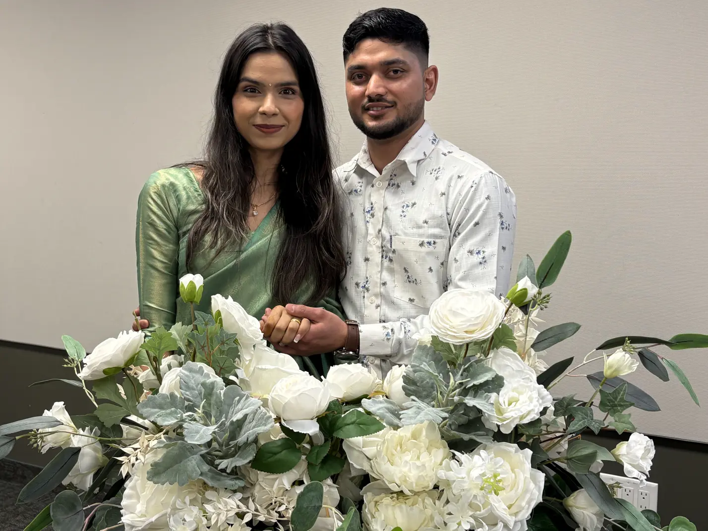 Couple seated holding hands