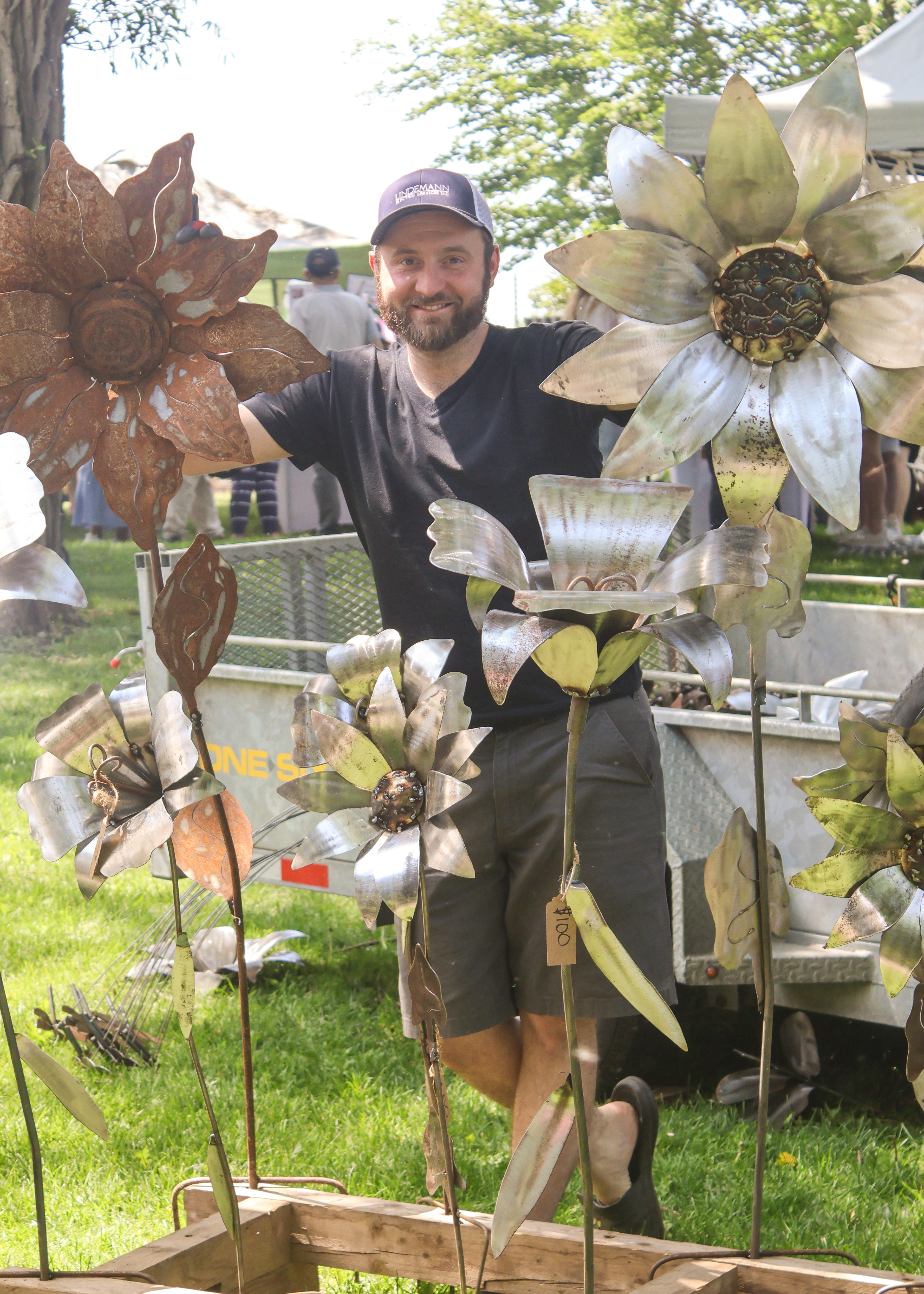 Iron works artist with steel welded giant flowers