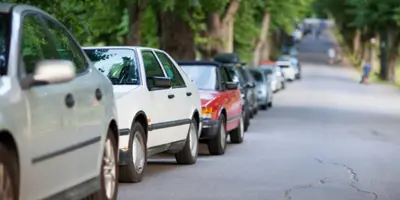 line of cars parked at the side of a street