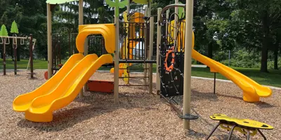 wood jungle gym with yellow slide