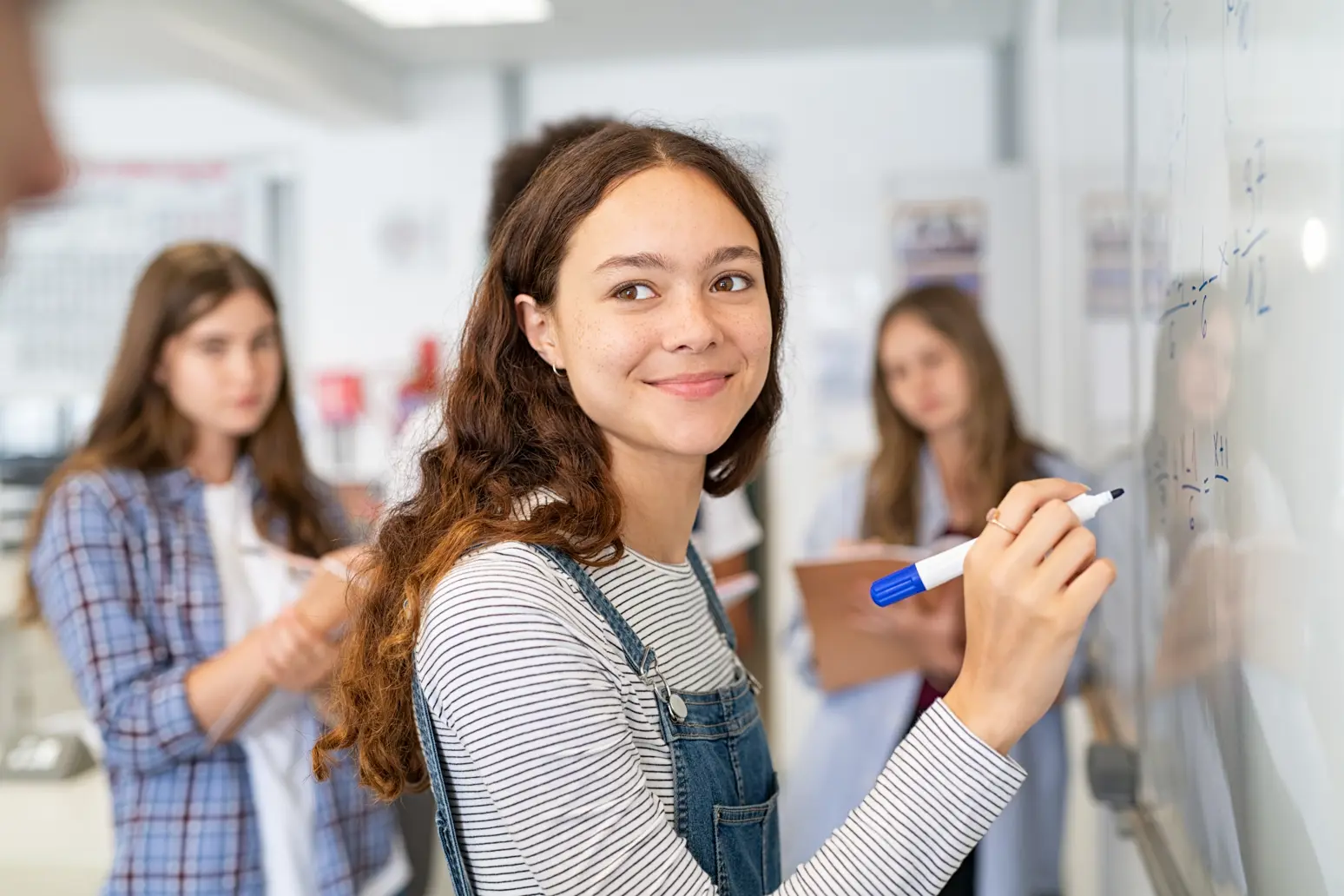 Teen girl at whiteboard