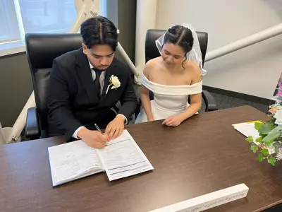 Couple signing marriage licence