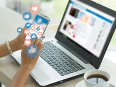 person checking mobile phone and laptop