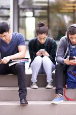 group of people on phones and devices