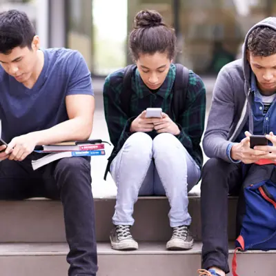 group of people on phones and devices