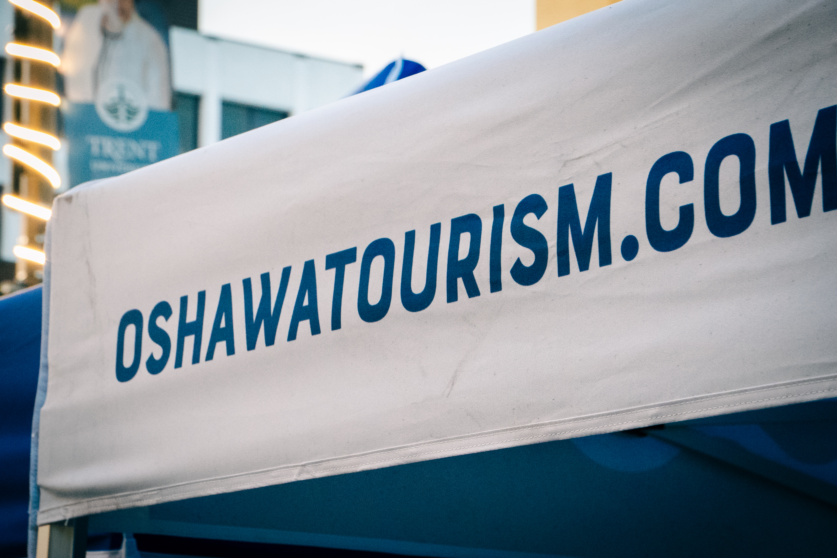 top canopy of tent with Oshawa Tourism website promotion