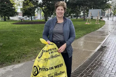 volunteer with garbage bag