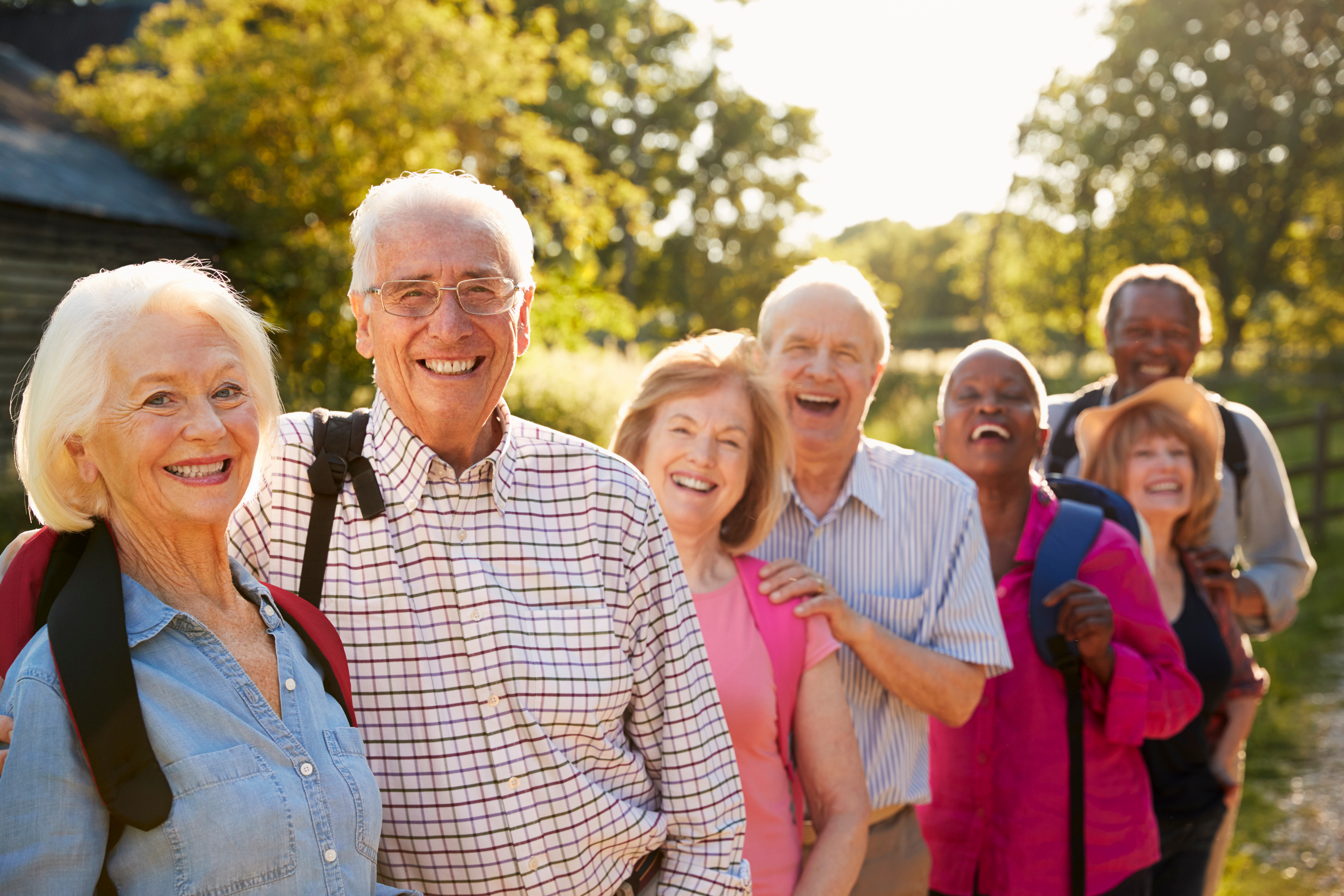 seven seniors hiking and smiling 