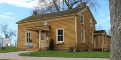 gold coloured one and a half storey heritage house