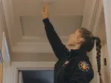 Fire person testing smoke detector