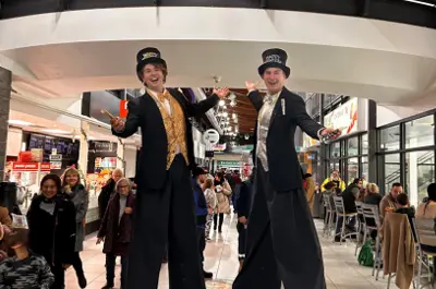 two stilt walkers with New Year's outfits