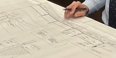 hand on blue prints
