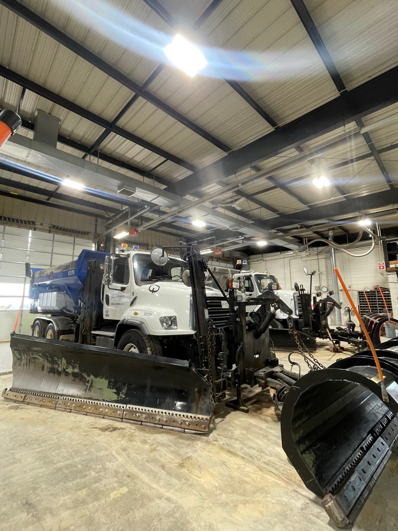 two snow ploughs parked inside garage