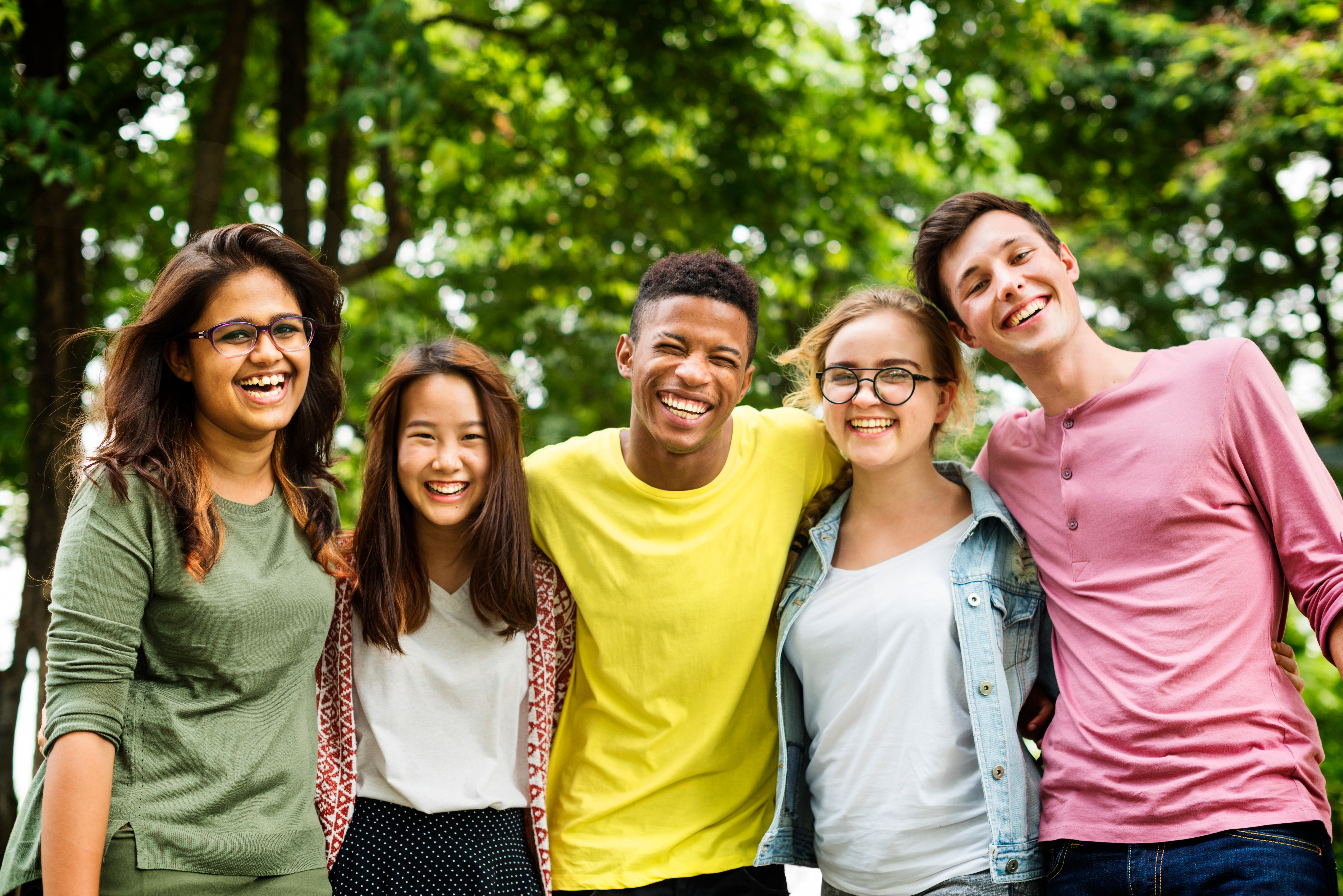 Group of teens standing in front of trees
