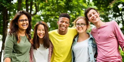 Group of teens standing in front of trees