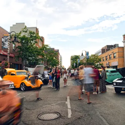 artistic blurry photo of downtown street with classic cars
