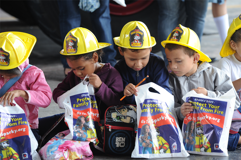 Kids in fire hats with loot bags