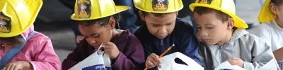 Kids in fire hats with loot bags