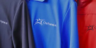 three shirts with City of Oshawa logo