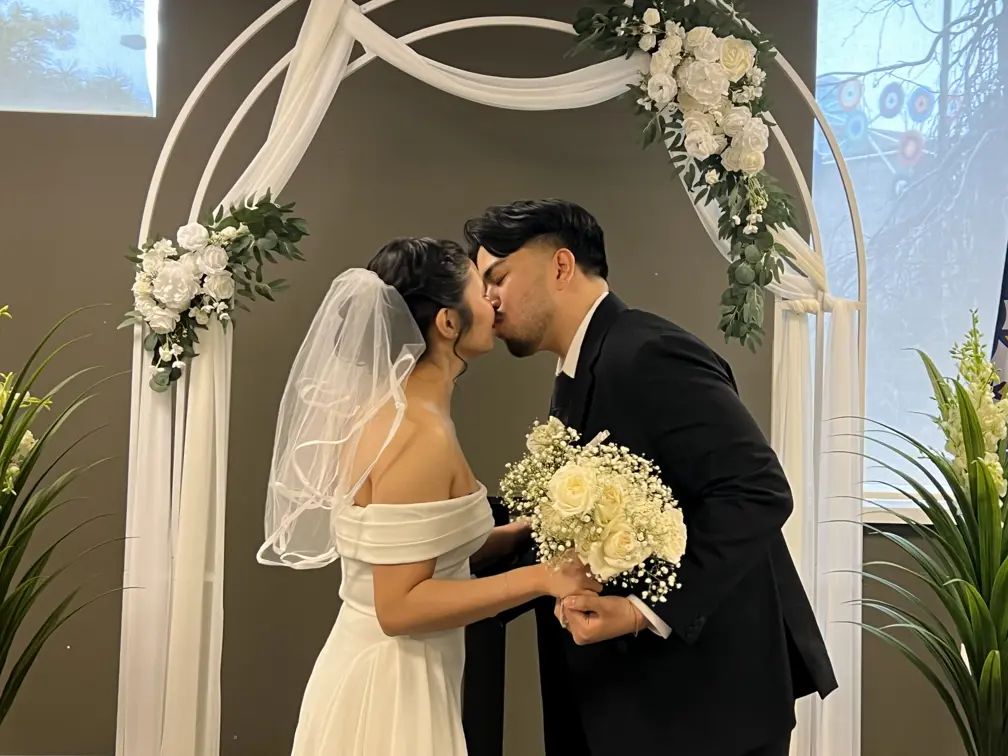 Couple kissing at the altar