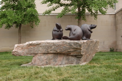 Three beavers on a rock in front of the RMG