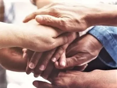 people's hands stacked