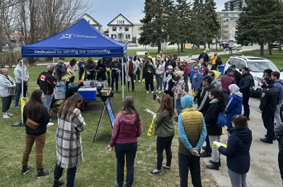 group of community cleanup volunteers gathering at tent