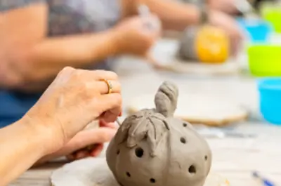 person doing pottery